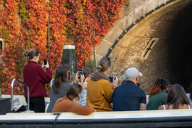 Amsterdam 1-Hour Canal Cruise With Live Guide - Houseboats, boutiques, and the city’s everyday side