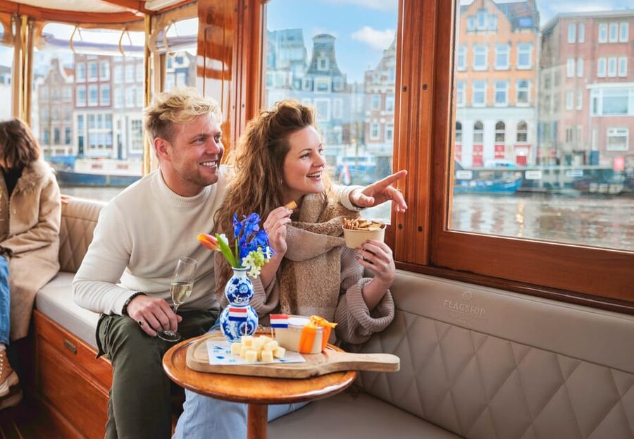 Amsterdam: Canal Cruise with Bubbles & Bites - Boarding the covered classic boat