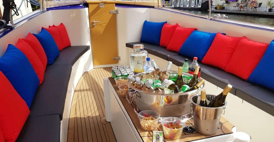 Amsterdam: Covered Canal Booze Cruise with Unlimited Drinks - Leaving the city center near the Red Light District