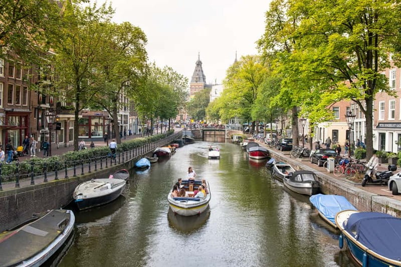 Amsterdam: Open Boat Tour of Canals with Expert Local Guide - Amsterdam Centraal and the first canal views