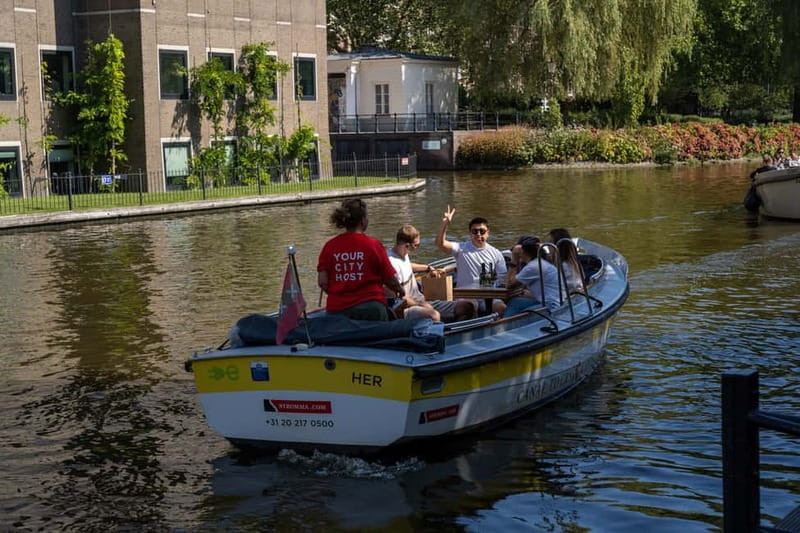 Amsterdam: Open Boat Tour of Canals with Expert Local Guide - Outdoor seating, blankets, and weather