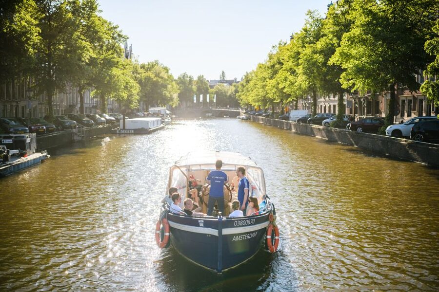 Amsterdam: Red-Light District Pub Crawl and Booze Boat Tour - Four pubs, drinking games, and a changing group