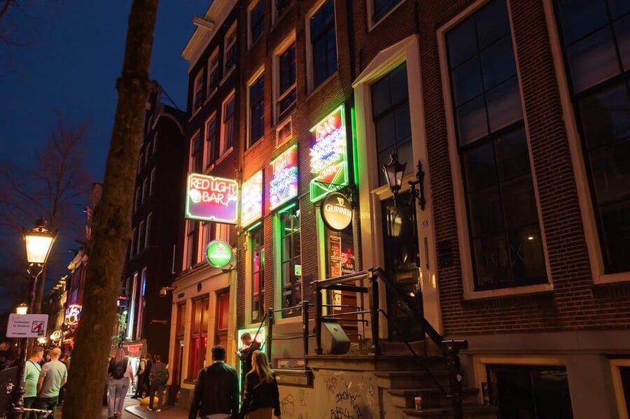 Amsterdam: Red Light Tour Exclusive + Peep Show - Oude Kerk beside the red windows