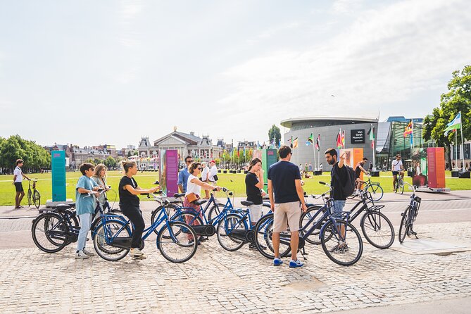 Amsterdam Small-Group Bike Tour With Optional Canal Cruise - Riding Amsterdam from Nieuwezijds Voorburgwal