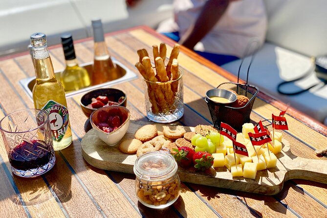 Amsterdam Small-Group Canal Cruise Including Snacks and Drinks - Daylight, evening lights, and seasonal comfort