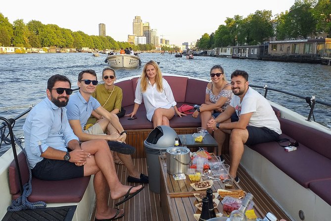 Guided Amsterdam Canal Cruise – Snacks & Drinks on board(1 Hour) - Why a small boat changes the Amsterdam canal experience