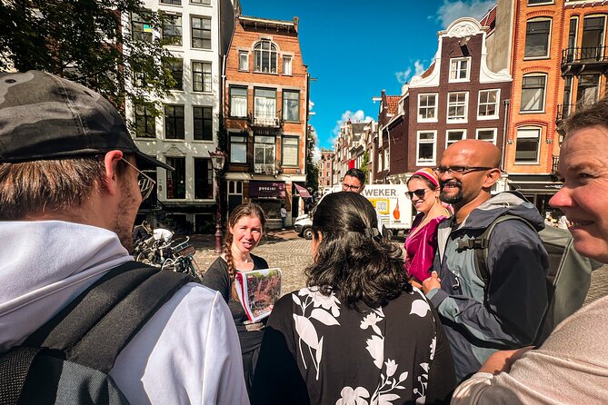 Small Group Walking Tour - Hello Amsterdam - Damrak: dancing houses and a true-or-false game